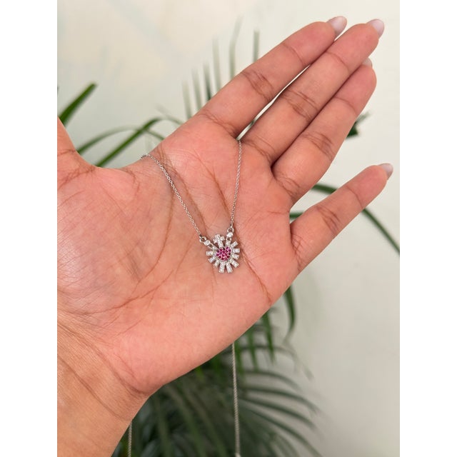 This sacred heart pendant necklace features a 0.13 carat, set in 14K white gold. Each ruby measuring around 1.2 mm....