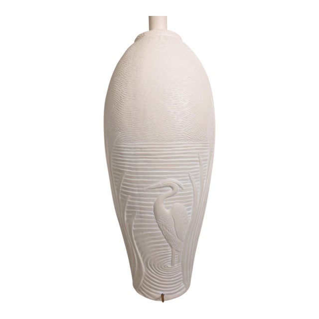 A striking vintage sculptural table lamp by Dayle Rushall, featuring a deeply raised heron/egret motif against a textured...