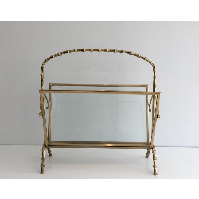 Faux-bamboo brass magazine rack with clear glass panels on each side. French work by Maison Baguès. Circa 1940