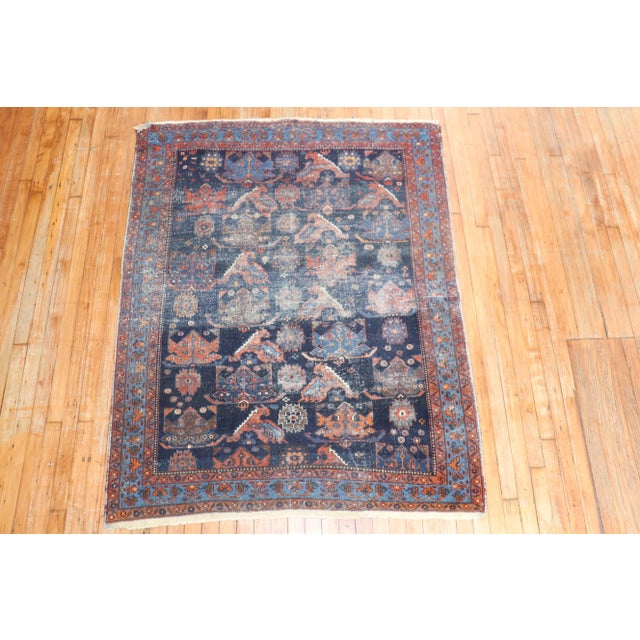 An early 20th Century Scatter square size tribal Persian Tafshar with an all-over design on a navy field. Professionally...