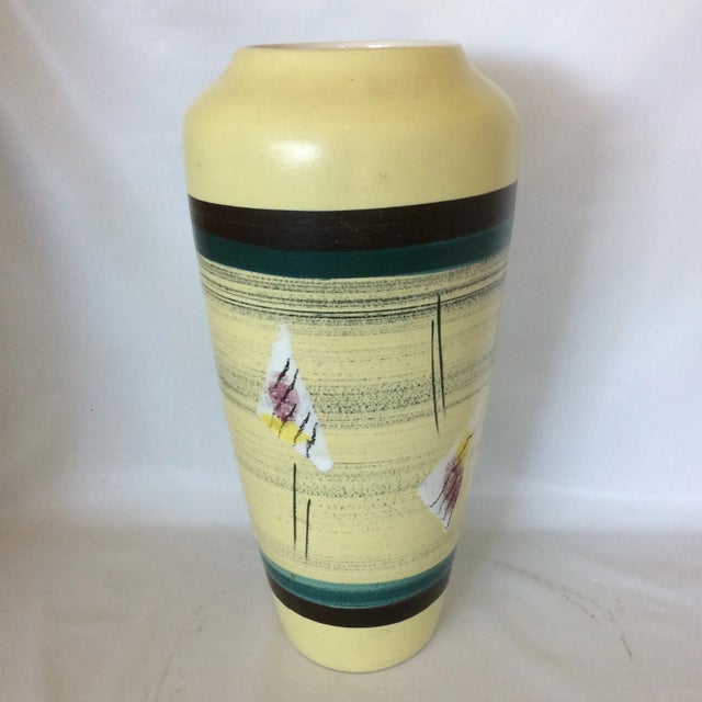 Beautiful Mid-Century Modern vase made in West Germany by Bodo Mans. Light yellow with abstract design and bands of black...