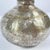 Vintage metal bottle from India with a rounded body. Made from polished metal with visible wear and repair marks. This...