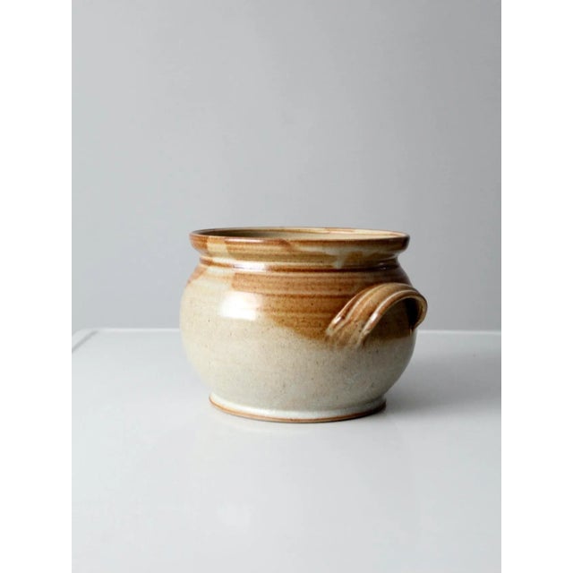 Vintage studio pottery serving bowl with a hand-crafted, artisan feel. This large ceramic bowl features raised side...