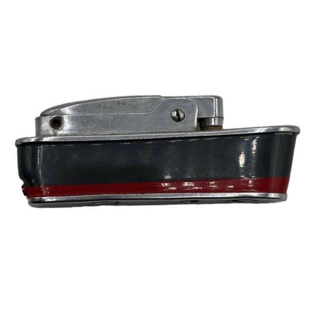 Mid-Century Sarome 'Cruiser' lighter, shaped like a Cruise ship, features a chrome body enameled red and grey accents. It...