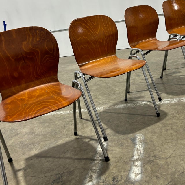Set of four mid-century modern bentwood stacking chairs featuring beautifully sculpted plywood seats and backs with...