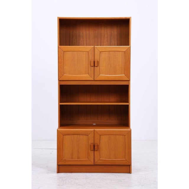 Vintage teak cabinet from Ejsing Møbelfabrik in Denmark. The combination of open shelves and closed storage space offers...