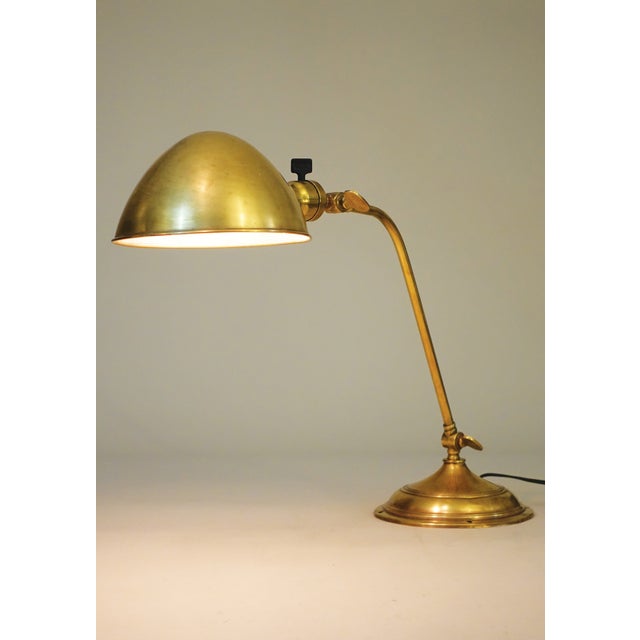 A brilliant and exceptional early Art Deco styled Industrial Machine Age Brass articulating extension table lamp designed...