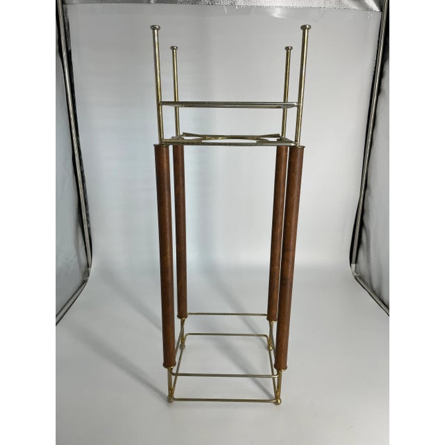 This stylish wooden and brass plant stand adds panache to any room. It gives Art Deco vibes, but could easily be used in a...