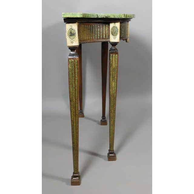 With replaced faux marble top over a conforming frieze with central marble panel with urn inlay flanked by fluting and...