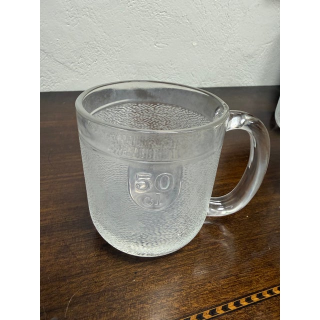 Set of six textured glass beer mugs designed by Oiva Toikka. Could be manufactured for iittala or Nuutajarvi. The mugs are...