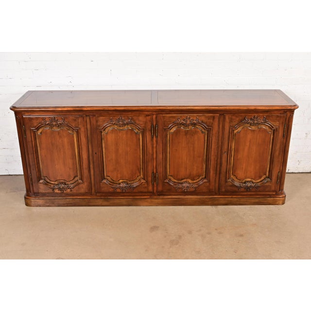 A gorgeous French Country or French Provincial Louis XV style sideboard, credenza, or bar cabinet By Baker Furniture USA,...