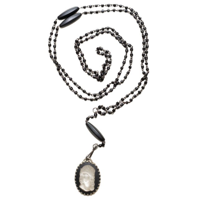 This vintage black beaded wrap necklace is from the 1940's and has a Lalique glass cameo as the pendant. This is very...