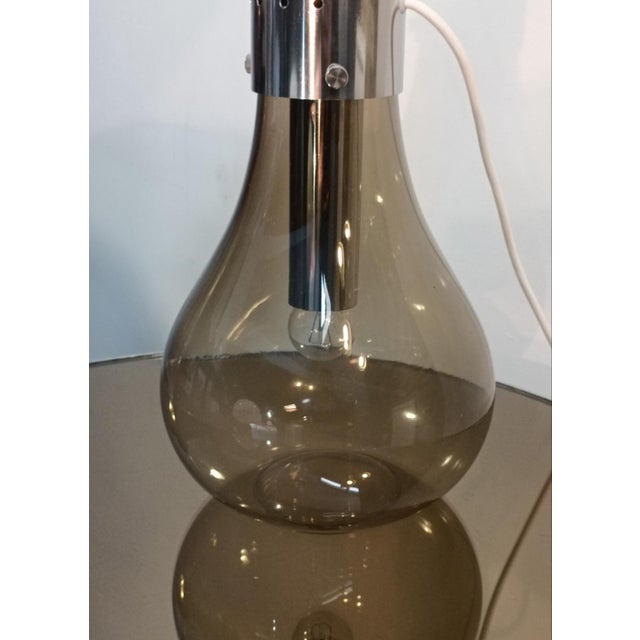 A magnificent lamp attributed to Mazzega. Italy, 1970s. ::::::: Murano glass. Two blown glass shades, separated by a...