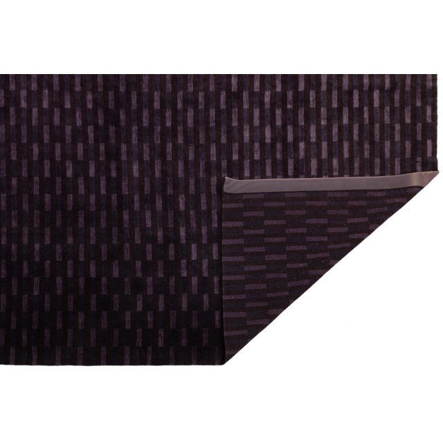 A striking modern Tibetan rug, handwoven in Nepal from a refined blend of wool and silk. Featuring a rhythmic vertical...