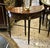 Bring refined European elegance to your interior with this beautiful demi-lune console table, crafted with a rich dark...