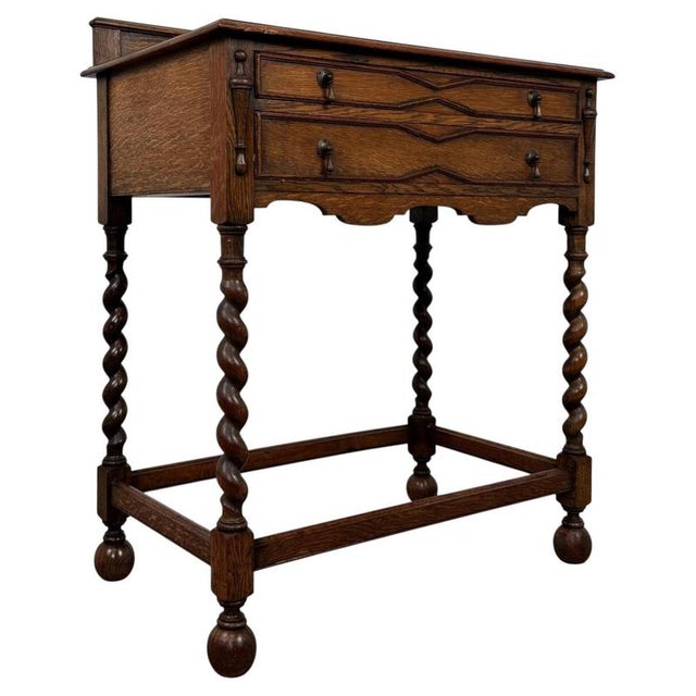 A handsome early 20th-century English side table in the Jacobean Revival style, finely crafted from oak and distinguished...