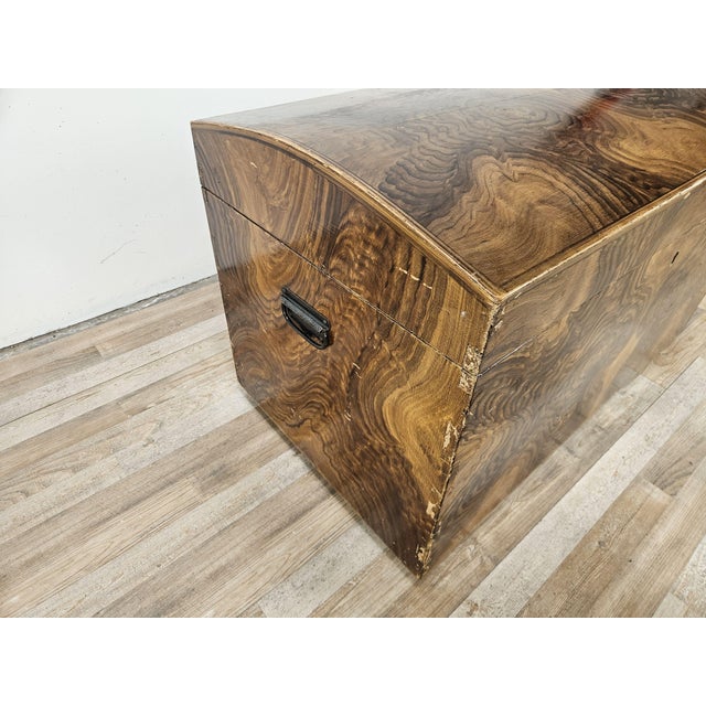 A 1950s Art Deco-style travel trunk, featuring clean, elegant lines that evoke the allure of grand voyages of the time. A...