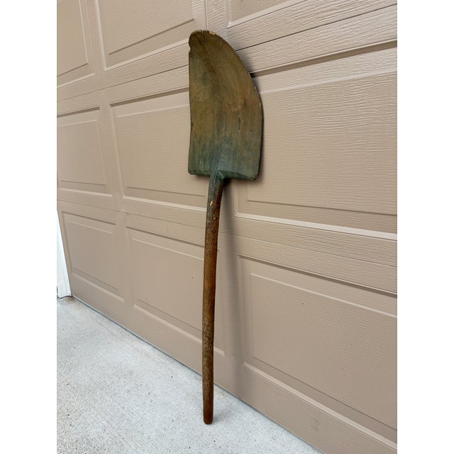 A wonderfully sculptural late 19th century wooden grain shovel garden tool, hand-hewn with a beautifully weathered surface...