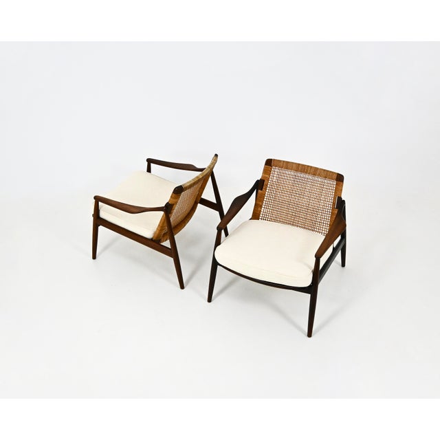 Pair of wood and fabric armchairs by Hartmut Lohmeyer, model 400. Seat height: 42 cm. Wear consistent with age and time....