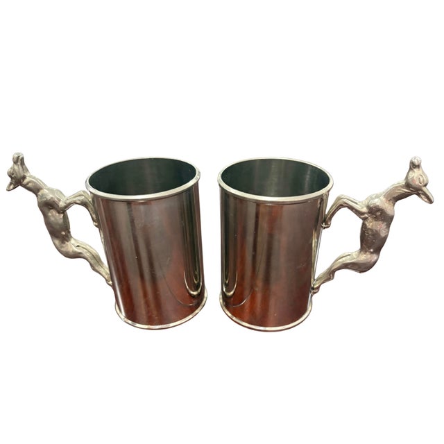 A distinctive pair of vintage Gucci Italy mugs featuring sculptural figural deer handles. Each cylindrical silver-tone cup...