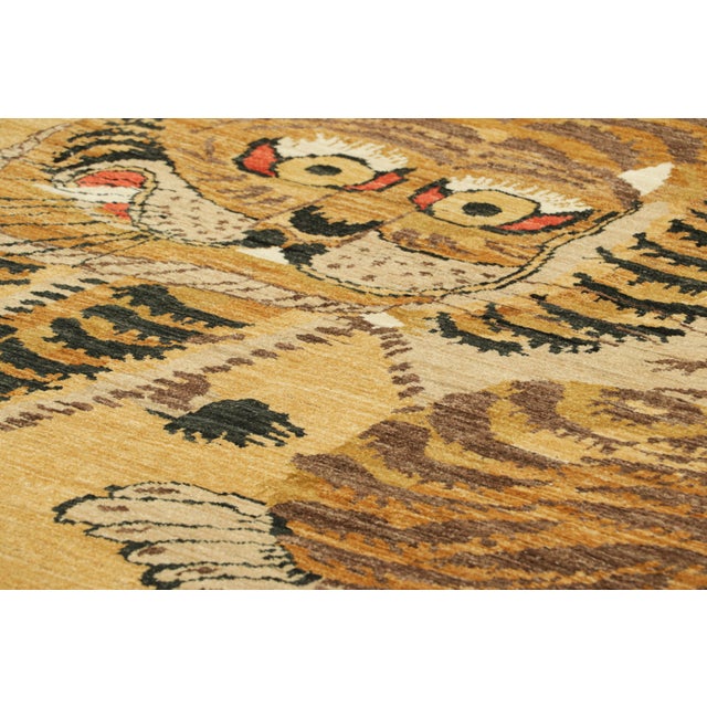 Hand-knotted in wool, this 6x10 modern tiger pictorial rug is a bold addition to the Rug & Kilim Tiger rugs line of their...