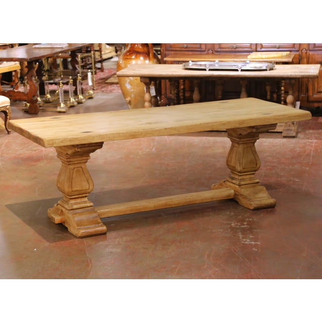 Crafted in France circa 1900, this impressive antique refectory dining table embodies the rustic elegance of traditional...