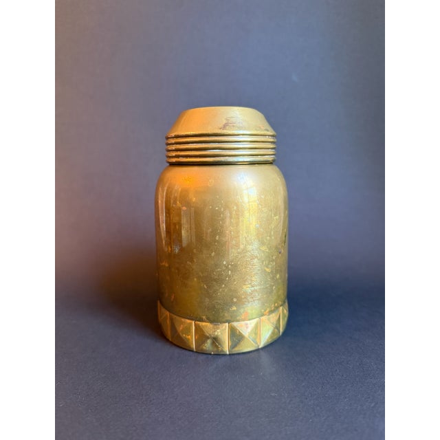 Elevate your decor with this exquisite vintage brass canister. Crafted from solid brass, this charming container features...
