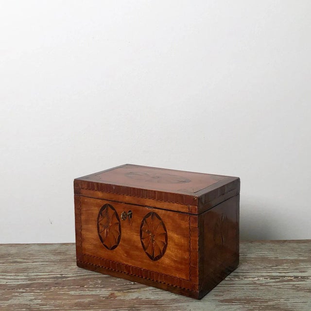 A late 18th Century English George III Period mixed woods, satinwood, kingwood, ebony and olive wood, tea caddy, circa 1790.