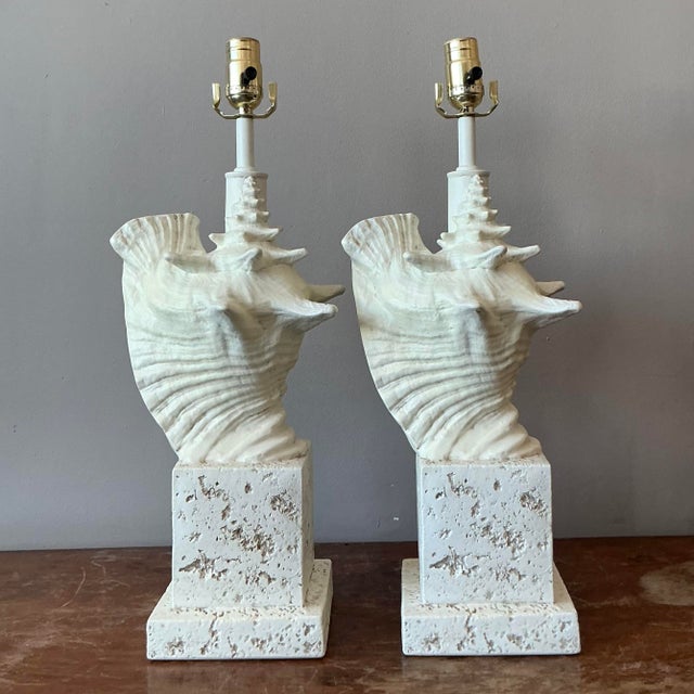 Presenting a stunning pair of vintage coastal lamps, each featuring an intricately cast plaster conch shell design resting...