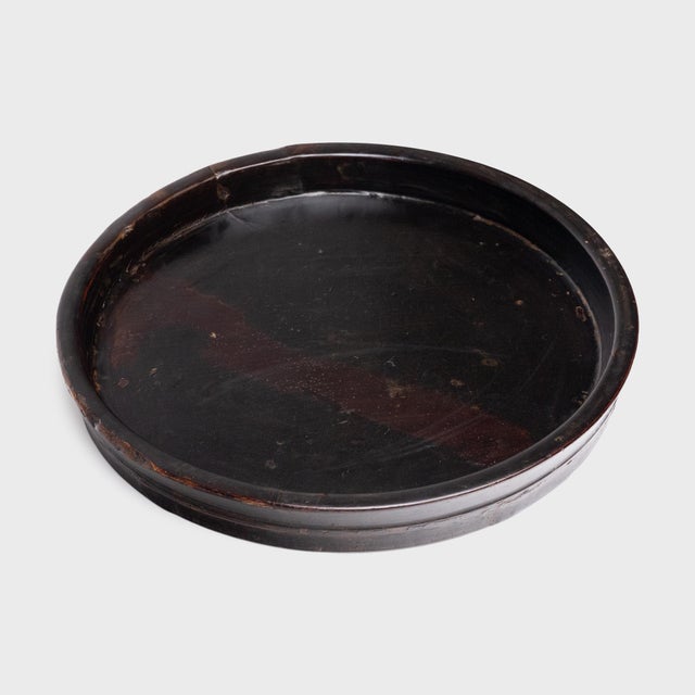 This antique Chinese tea tray from the late 19th century celebrates the beautiful simplicity of a handmade object. Richly...