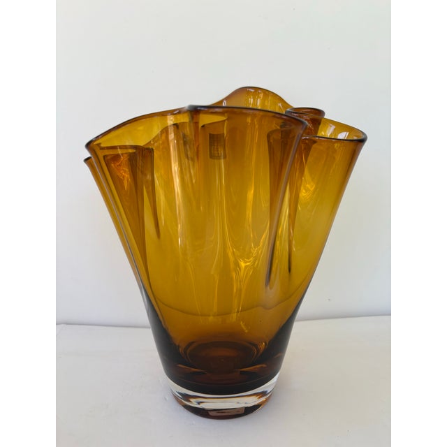 This striking handmade crystal vase from Poland features a rich amber color and an elegant freeform, ruffled rim that...