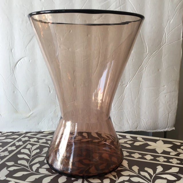 Lovely rose-champagne colored handblown glass vase with cinched center. Artist signed on bottom. The shape of this vase is...