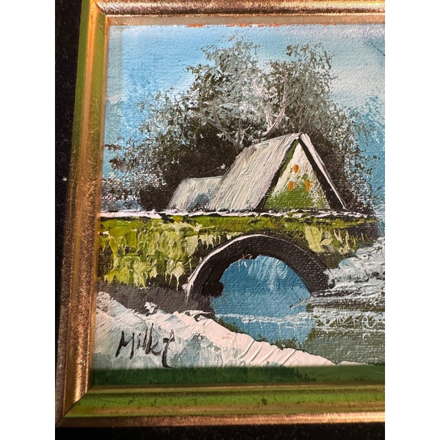 An original small oil on canvas board: a humped stone bridge over a partly frozen stream, a cottage or mill beyond, a bare...