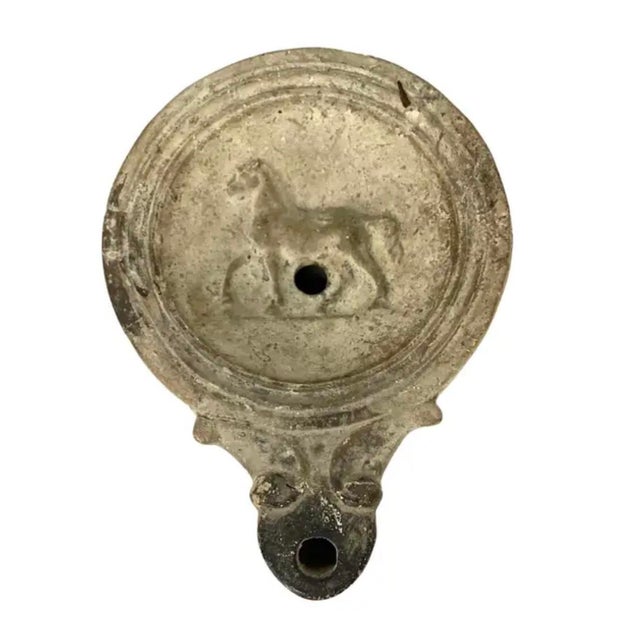 Roman Terracotta Oil Lamps, Set of Four, used as an alternative to candles, dating back to 2nd century A.D. These small...