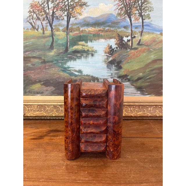 This antique likely burl wood bookend is a cleverly designed functional object featuring a hidden storage compartment....