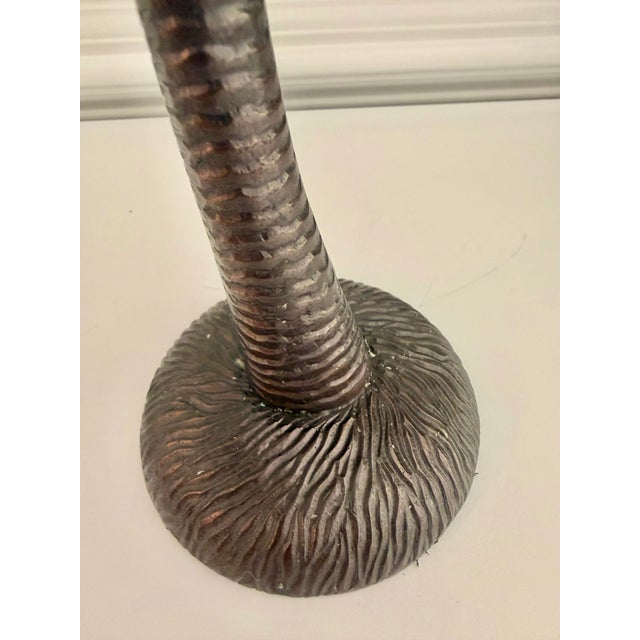 Bring a touch of tropical elegance to your home with this delightful pair of metal sculptural palm tree taper candle...