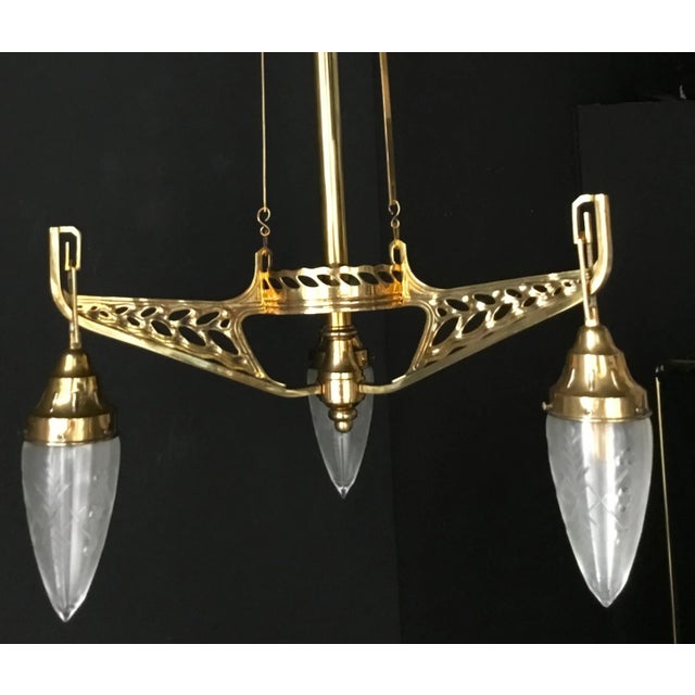 Stunning Art Nouveau chandelier from Vienna around 1900. The fine shaped, polished solid brass mounting shows the typical...
