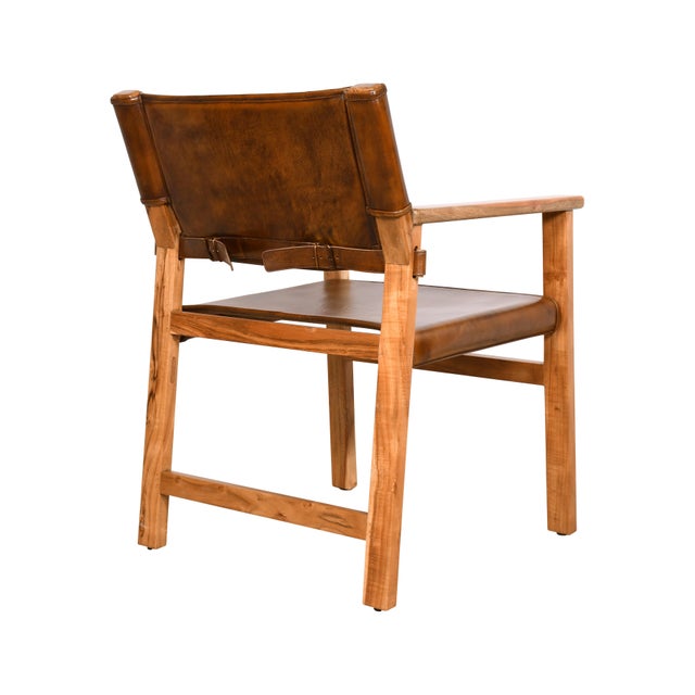 Featuring a rich, caramel-toned leather seat and backrest, this chair is supported by a warm natural wood frame that...