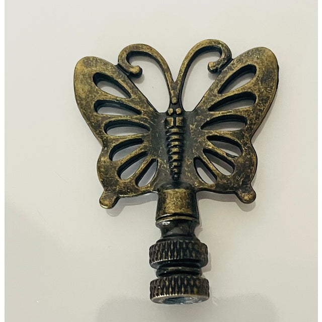 Vintage bronze butterfly lamp finial.