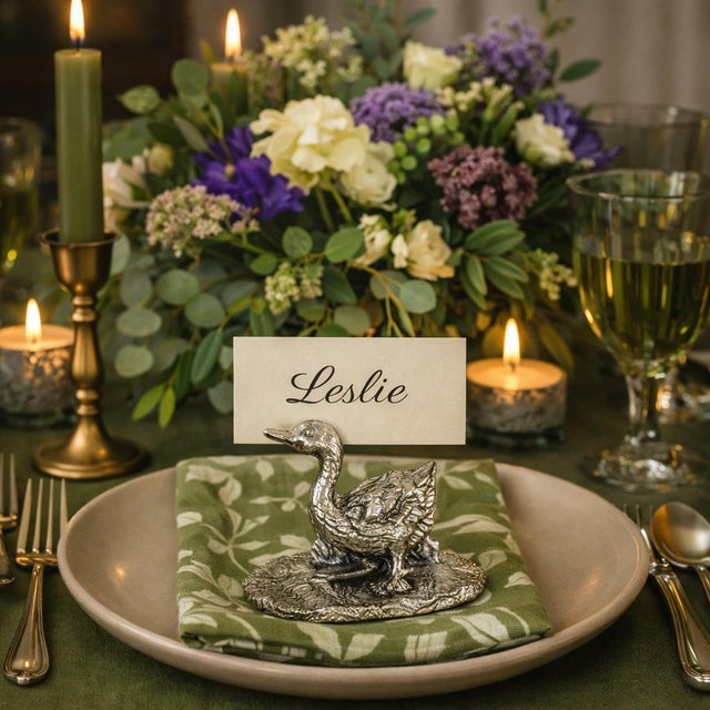 Elevate your table with a touch of quiet luxury: a complete set of 12 vintage pewter duck place card holders, crafted in...