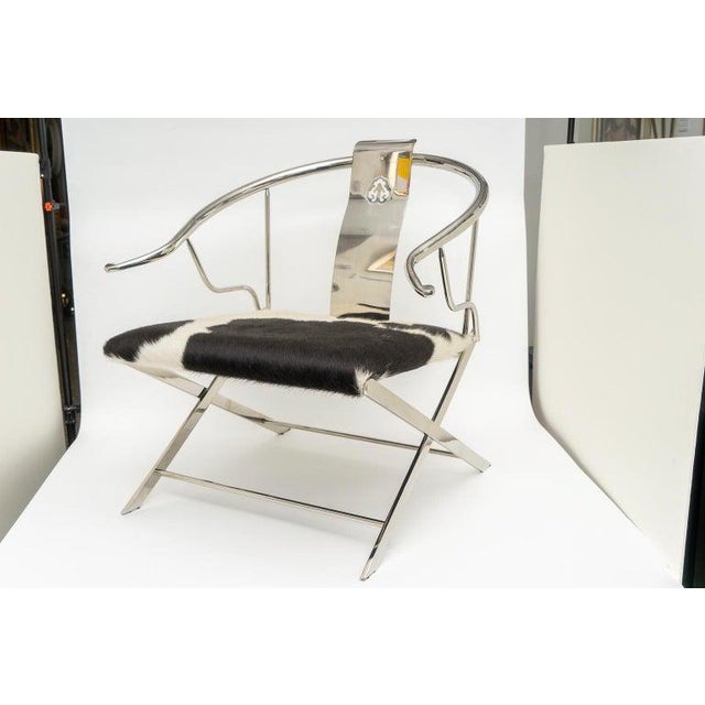 This stylish and chic modern take on a Classic Chinese "Horseshoe Back" armchair will make a definite statement with is...