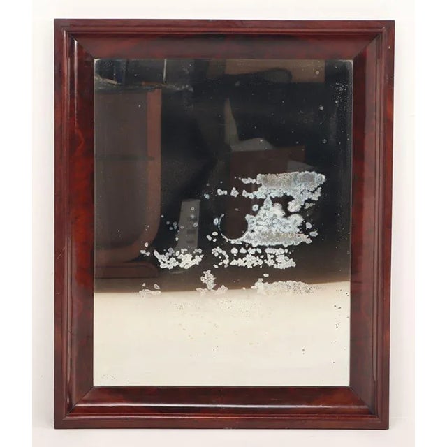 A crotch mahogany Empire wall mirror circa 1830.