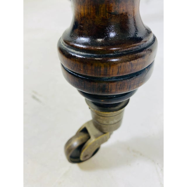 This is a Lillian August leather topped side table. This round side table has four fluted legs with solid brass casters at...
