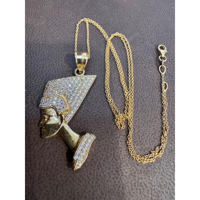 A Face Pendant wearing a hat full of diamonds Approximately 1 ct of brilliant round cut diamond Pendant crafted in 14...