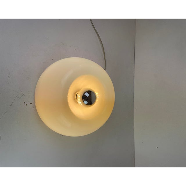 Beautiful flush-mount or wall lamp made of a lacquered metal base with a wide, dome-shaped shade of blown, glossy white...