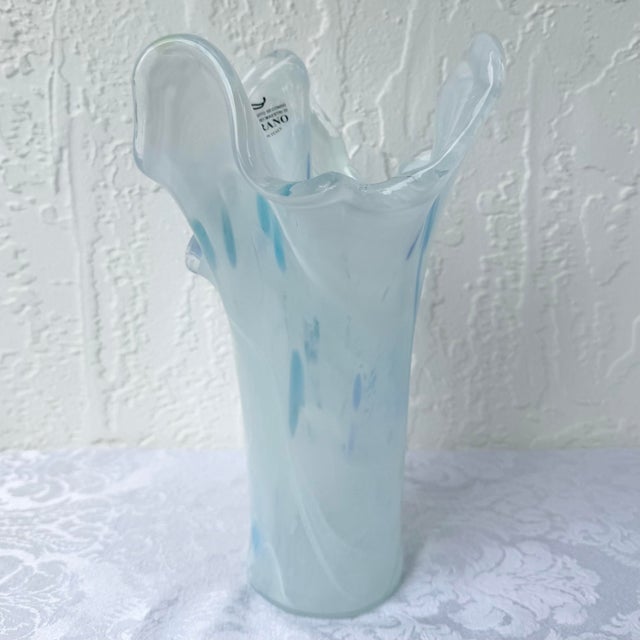 An elegant Italian hand-blown art glass vase crafted in the Murano tradition, featuring a graceful freeform silhouette...