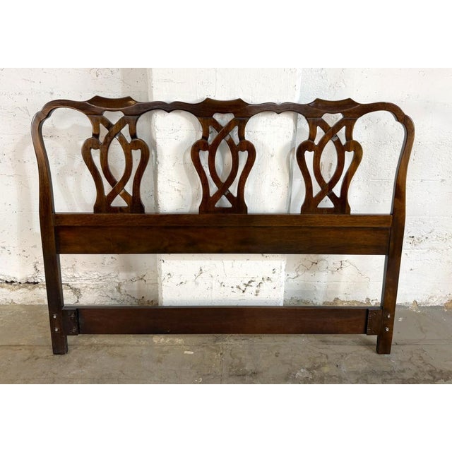 This Drexel 18th Century Collection headboard features a rich wood finish with an openwork back showcasing graceful...