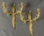 A gorgeous pair of antique French Rococo style gilt brass candelabra two arm candle wall sconces. These beautiful sconces...