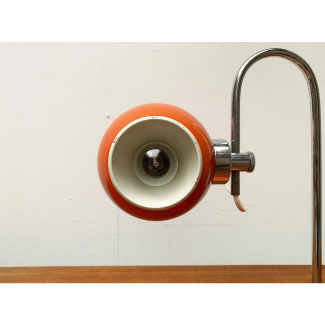 Space Age table lamp with ball reflector on magnetic holder. A striking detail of this luminaire is the spherical...