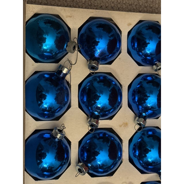Vintage set of 12 vintage Mercury glass ornaments. A deep blue mercury glass with metal cap. The glass ornaments show wear...